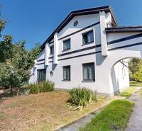 A family house on Mandľová Street, Bratislava - Jarovce with an arched entrance and a garden.