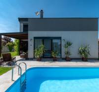 A family house in Kvetoslavov with a swimming pool and terrace, surrounded by a green garden.