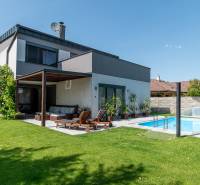 A family house in Kvetoslavov with a pool and a terrace in a sunny garden.
