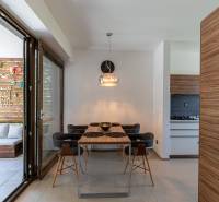 Dining area with a wooden table and comfortable chairs in a family house.