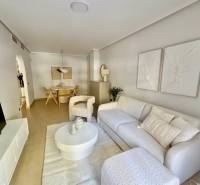 Living room of a holiday apartment with white furniture and decorations on the walls.