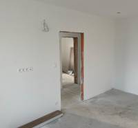 Construction of houses with white walls and unfinished interior details.