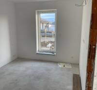 An empty room with white walls and a large window, House construction.