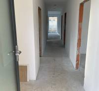 Corridor under construction with several rooms and raw walls, House construction.