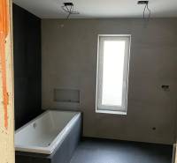 Building a bathroom with a bathtub and tiles, House construction.