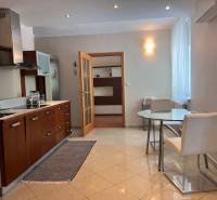 A kitchen with a dining table and chairs in a 3-room apartment.