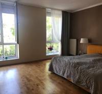 Bedroom in a 3-room apartment with wide windows and wooden flooring.