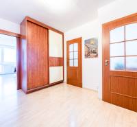 Wooden interior doors and a built-in wardrobe in a 3-room apartment with light flooring.