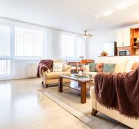Living room in a 3-room apartment with a sofa, coffee table, and bookshelf.