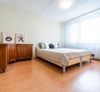 A bright bedroom with a wardrobe and a bed in a 3-room apartment.