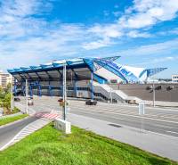 In Košice, in the Juh district on Žižkova Street, a sports arena can be seen with a clear sky.
