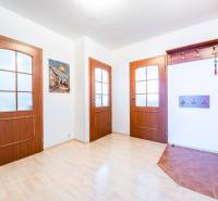 Entrance hall with wooden door and coat rack in a 3-room apartment.