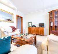 A living room with sofas and wooden furniture in a 3-room apartment.