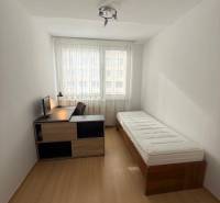 A bright room with a bed and a table in a 3-room apartment.