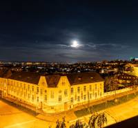 Night panorama of Košice - Juh district from Žižkova Street, illuminated buildings and road.