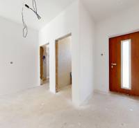 Interior of a family house with white walls and wooden doors, empty room.