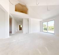 A bright spacious room in a family house with large windows.