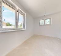 A stylish room in a family house with light walls and large windows.