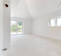 A spacious, bright room with large windows in a family house.