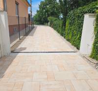 A family house with a paved walkway on Roľnícka Street in Bratislava - Vajnory.