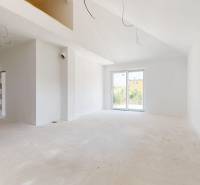 A family house with a spacious room, an open window, and balcony doors.
