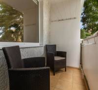 A balcony with two rattan chairs in a 3-room apartment.