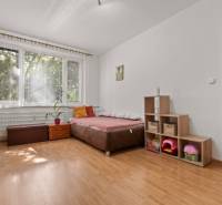 A bright room with a bed and storage space in a 3-room apartment.