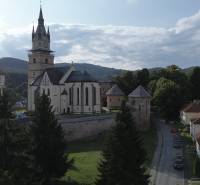 Kremnica - a historical church surrounded by greenery, with a view of the town.