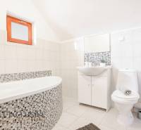 Bathroom with a bathtub and sink in hotels and guesthouses, bright tiles, minimalist style.