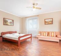 Interior of rooms in hotels and guesthouses with a wooden bed, sofa, and paintings.