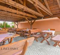 Wooden terrace with benches in hotels and guesthouses in Veľký Meder.