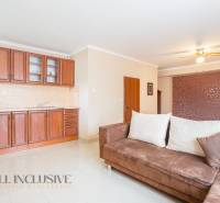 The interior of kitchenettes in hotels and guesthouses with a sofa and wooden cabinets.