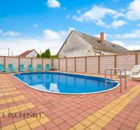 A pool with loungers in Veľký Meder, ideal for hotel and guesthouse visitors.