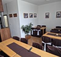 Interior with wooden tables, chairs, and decorations in a studio apartment.