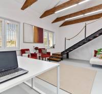 Office interior with a staircase, furniture, and decorations, pleasant working atmosphere.