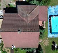 A family house in Vyšná Myšľa with a swimming pool, aerial view, visible roof and garden.