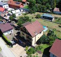 Aerial view of family houses in Vyšná Myšľa surrounded by gardens and greenery.