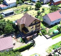 A family house in Vyšná Myšľa with surrounding garden and additional buildings.