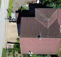 Aerial view of the roof of a family house in Vyšná Myšľa with a pool in the garden.