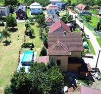 A family house in Vyšná Myšľa with a swimming pool, garden, and surrounding houses.