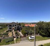 A family house in the village of Vyšná Myšľa with a view of the garden and the surrounding countryside.