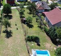 Aerial view of a garden with a pool and fruit trees by a family house in Vyšná Myšľa.