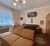 A sofa and a chandelier in the living room of a family house with furniture and decorations.