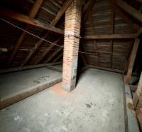 Attic space with a brick chimney on Lietavská Lúčka street, ideal for a 3-room apartment.
