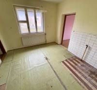 An older interior of a 3-room apartment on Lietavská Lúčka street, with tiles and a radiator under the window.