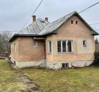 An older house on Lietavská Lúčka street surrounded by a lawn, suitable for a 3-room apartment.