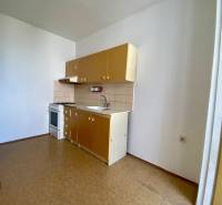 A kitchen in a 3-room apartment with a gas stove and cabinets.