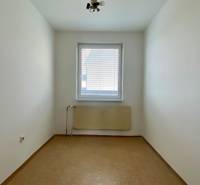 A small room with a window and a radiator in a 3-room apartment.