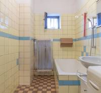 Bathroom in a family house with tiles and an older radiator.
