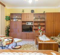 Retro living room in a family house with furniture, carpets, and accessories.